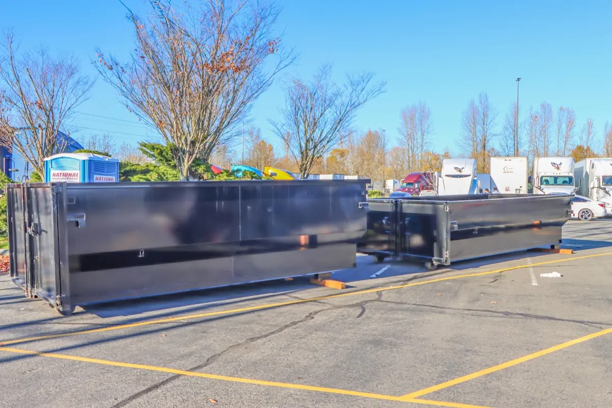 Professional dumpster rental service with roll-off container on residential driveway in Fairmount